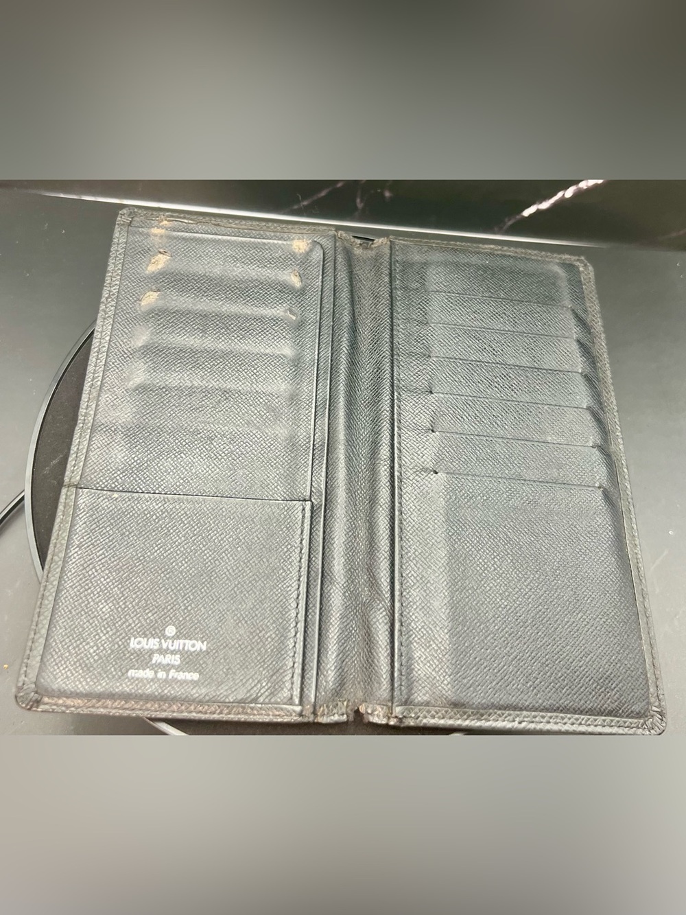 Louis Vuitton Taiga leather Brazza wallet in black. Fair condition. Unisex